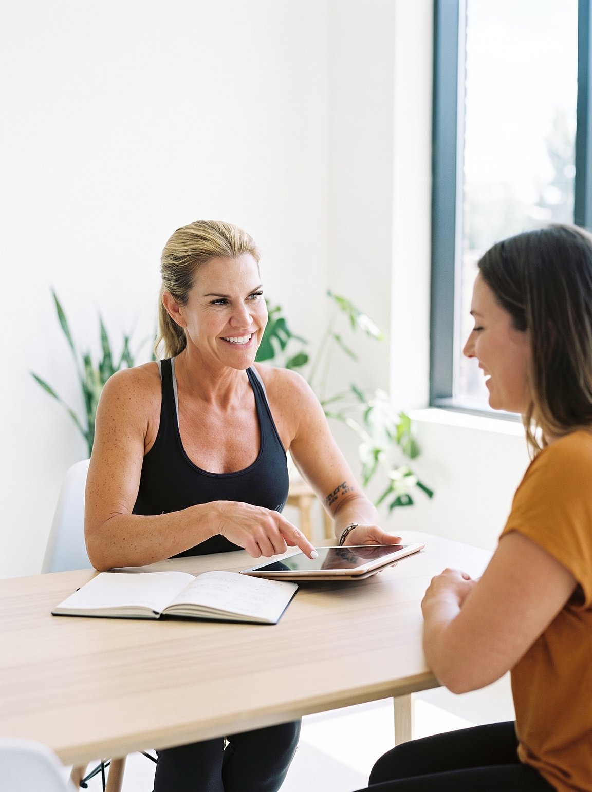 Fiona Rooney talking a client through their weekly plan at a table
